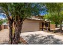 Charming home with a two-car garage and xeriscaped front yard for low-maintenance appeal at 5320 E Silverbell Rd, San Tan Valley, AZ 85143