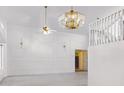 An elegant living room with recessed panel walls and modern light fixtures at 5742 W Shannon St, Chandler, AZ 85226