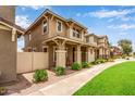 Street view of attractive two-story homes, each with welcoming front porches, desert landscaping, and well-kept sidewalks at 5840 E Holmes Ave, Mesa, AZ 85206