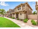 View of stylish homes with front porches, manicured landscaping, sidewalks, and beautiful blue sky in a pleasant neighborhood at 5840 E Holmes Ave, Mesa, AZ 85206
