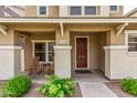 Inviting front porch with seating, desert landscaping, and attractive front door creating curb appeal for this lovely home at 5840 E Holmes Ave, Mesa, AZ 85206
