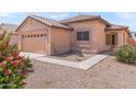 Inviting front exterior features a desert landscape, tile roof, and covered entryway for a welcoming feel at 684 E Redondo Dr, Gilbert, AZ 85296