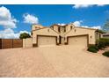Spacious two-story home featuring a paved circular driveway and a three-car garage at 7432 W Bronco Trl, Peoria, AZ 85383