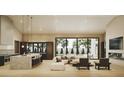 Bright, open-concept living room featuring a modern kitchen, white sofa, and a view of the pool at 7445 E Vista Dr, Scottsdale, AZ 85250