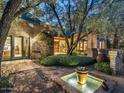 Inviting outdoor area featuring a tranquil fountain, lush greenery, and cozy brick details at 8022 N Ironwood Dr, Paradise Valley, AZ 85253