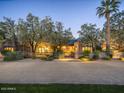 Charming home with mature trees, brick accents, and stylish landscaping offers privacy and curb appeal at 8022 N Ironwood Dr, Paradise Valley, AZ 85253