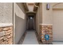 Inviting front entrance with stone accents and a secure security system, ensuring peace of mind at 10033 W Jessie Ln, Peoria, AZ 85383