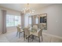 Elegant dining area with modern chandelier, large window, and stylish mirrors at 11333 N 92Nd St # 1075, Scottsdale, AZ 85260