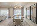 Bright dining area with modern light fixture, glass table, and elegant mirrors at 11333 N 92Nd St # 1075, Scottsdale, AZ 85260