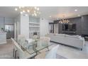 Bright and spacious living room featuring a modern light fixture and glass dining table at 11333 N 92Nd St # 1075, Scottsdale, AZ 85260