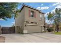 Angle view of the front of the home featuring a spacious two-car garage and landscaped yard at 1145 E Harold Dr, San Tan Valley, AZ 85140