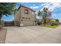 View of the home featuring a spacious two-car garage and landscaped yard at 1145 E Harold Dr, San Tan Valley, AZ 85140