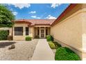 Inviting home entrance with pathway and manicured landscaping, creating a welcoming approach at 11524 W Rosewood Dr, Avondale, AZ 85392