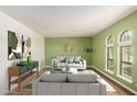 Staged living room featuring stylish sofas, green accent wall, and arched windows at 12835 N 16Th Dr, Phoenix, AZ 85029