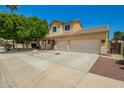Attractive two-story home featuring a two-car garage and low-maintenance desert landscaping at 12950 W Alegre Dr, Litchfield Park, AZ 85340