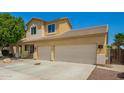 Well-maintained two-story house featuring a two-car garage and easy desert landscaping at 12950 W Alegre Dr, Litchfield Park, AZ 85340