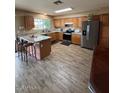Spacious kitchen featuring wood cabinets, stainless steel appliances, and a center island at 1616 W Temple St, Chandler, AZ 85224