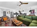 Open concept living room featuring wood-look floors, comfortable seating, and access to the kitchen and dining area at 1747 E Grove St, Phoenix, AZ 85040