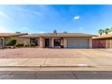 Charming single-story home with a well-maintained front yard and a two-car garage at 1802 W Isleta Ave, Mesa, AZ 85202