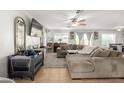 Comfortable living area featuring neutral colors, tile flooring and a ceiling fan at 181 N 222Nd Dr, Buckeye, AZ 85326