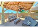 Spacious outdoor living area with comfortable seating, a TV, and a built-in grill at 18195 W Marshall Ln, Surprise, AZ 85388