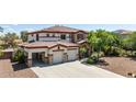Beautiful two-story home featuring a stone-accented facade, a red tile roof, and a spacious three-car garage at 18329 W Montebello Ave, Litchfield Park, AZ 85340