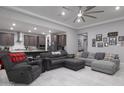 Open-concept living room flowing into the kitchen with modern gray finishes at 18493 W Hiddenview Dr, Goodyear, AZ 85338