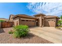 A home with desert landscaping, three car garage, and a stone accent entry at 241 W Roadrunner Dr, Chandler, AZ 85286