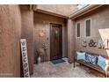 Welcoming front porch with tiled floors, bench, and a decorative iron door at 241 W Roadrunner Dr, Chandler, AZ 85286