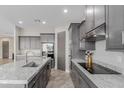Well appointed kitchen featuring an island, granite countertops, stainless steel appliances, and gray cabinetry at 2516 W Joy Ranch Rd, Phoenix, AZ 85086