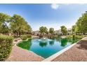 Scenic view of a pond with a fountain and bridge, enhancing the community's natural beauty at 2631 S Sulley Dr # 106, Gilbert, AZ 85295