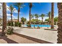 Community pool surrounded by palm trees, offering a refreshing oasis for residents at 2631 S Sulley Dr # 106, Gilbert, AZ 85295