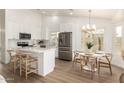 Well-lit kitchen featuring white cabinets, stainless steel appliances, and a cozy dining nook at 325 N Redrock St, Gilbert, AZ 85234