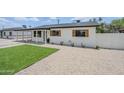 Beautifully renovated single-story home with fresh exterior paint, a covered carport, and rock landscaping at 3609 E Palm Ln, Phoenix, AZ 85008