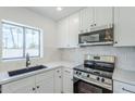 Close up of the spacious kitchen, with stainless steel appliances and a lovely window at 3609 E Palm Ln, Phoenix, AZ 85008