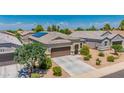 Lovely single-story home with a tile roof, solar panels and a well-maintained front yard at 36412 W Pampoloma Ave, Maricopa, AZ 85138