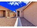 Inviting front entrance with a walkway leading to a dark-stained front door at 39985 W Rio Lobo Dr, Maricopa, AZ 85138