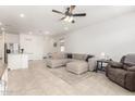 Open-concept living space features neutral colors, tile flooring, and comfortable seating at 39985 W Rio Lobo Dr, Maricopa, AZ 85138