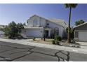 Charming two-story home with a white exterior, a two car garage and desert landscaping at 4530 E Desert Wind Dr, Phoenix, AZ 85044
