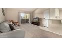 Cozy living room boasts sliding glass door access, seating, and entertainment center at 461 W Holmes Ave # 360, Mesa, AZ 85210
