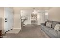Open-concept living area features neutral decor, sofa, and access to the kitchen at 461 W Holmes Ave # 360, Mesa, AZ 85210