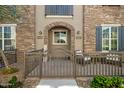 Charming home featuring a stone archway, a cozy patio, and a well-manicured front yard at 4716 E Red Oak Ln # 102, Gilbert, AZ 85297