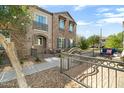 Beautiful two-story home with stone accents, a balcony, and a landscaped front yard at 4716 E Red Oak Ln # 102, Gilbert, AZ 85297