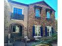 Inviting two-story home featuring a stone and stucco facade with a cozy front porch at 4716 E Red Oak Ln # 102, Gilbert, AZ 85297