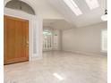 Bright foyer featuring large windows, skylights, neutral colors, and tile flooring at 4801 E Quien Sabe Way, Cave Creek, AZ 85331