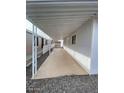 Long carport with gravel and cement flooring offers covered parking at 500 N 67 Ave # 149, Phoenix, AZ 85043