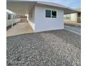 This property features a covered parking area, gravel landscaping, and a clean, modern exterior design at 500 N 67 Ave # 149, Phoenix, AZ 85043