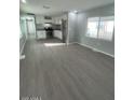 Open living room with a view into the updated kitchen with modern appliances and ample counter space at 500 N 67 Ave # 149, Phoenix, AZ 85043