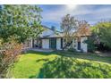 This single-Gathering house boasts a white exterior, mature shade trees, and an attached carport at 505 W Howe St, Tempe, AZ 85281