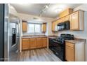 This updated kitchen features stainless steel appliances, hardwood-style floors, and a window at 505 W Howe St, Tempe, AZ 85281